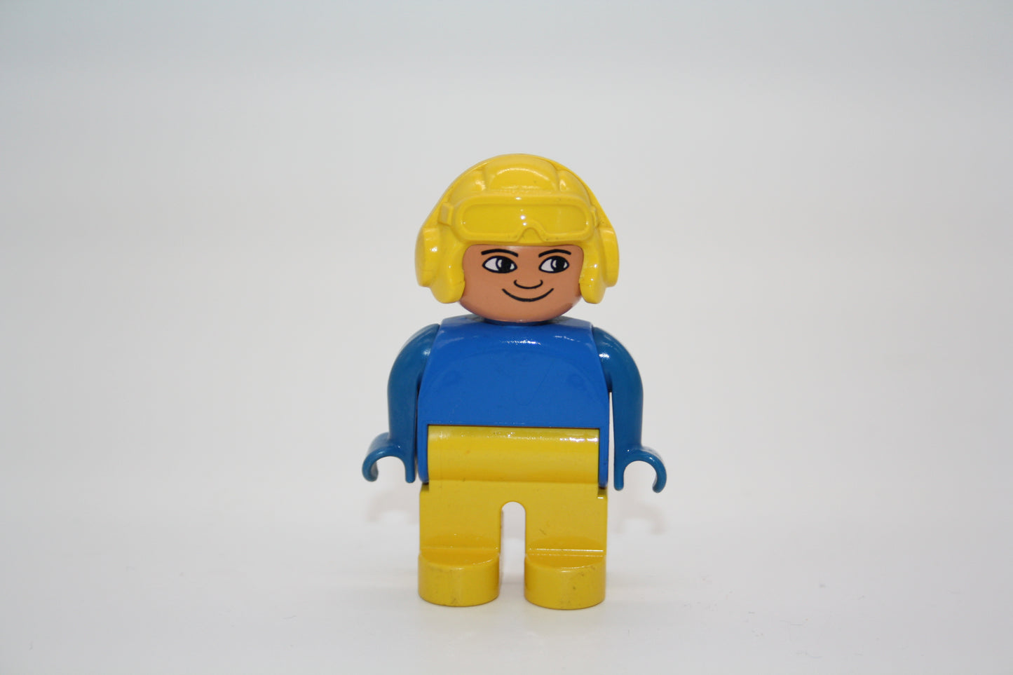 Duplo - Pilot/Rennfahrer alt - gelbe Hose/blaues Oberteil/gelber Helm - Mann - Figur
